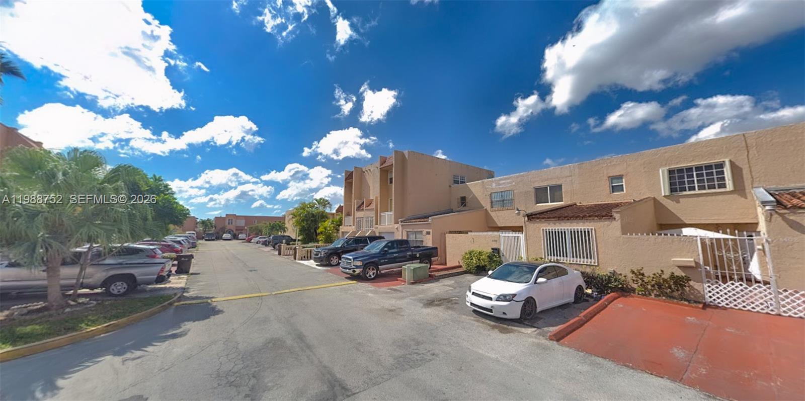 A street view shows a row of tan townhouses with parked cars in front — 4415 W 10th Ln # 14, Hialeah FL 33012, HIALEAH, FL