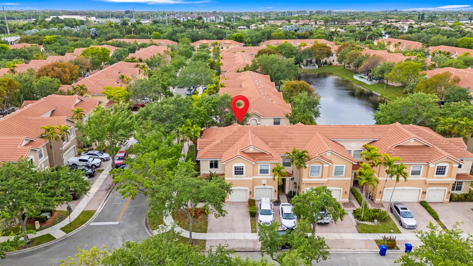 An aerial view shows a row of two-story townhouses with tile roofs and driveways — 12444 SW 42nd Street, Miramar FL 33027, MIRAMAR, FL