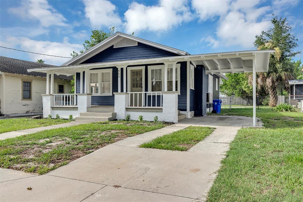 A blue house with a front porch, white trim, and an attached carport — 540 W HANCOCK STREET, LAKELAND, FL