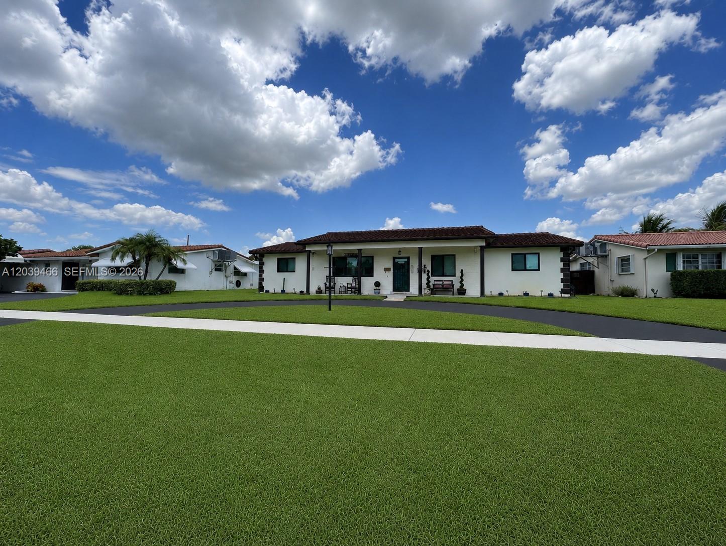 A single-story house with a dark tile roof and a circular driveway sits on grass — 4301 Adams St, Hollywood FL 33021, HOLLYWOOD, FL
