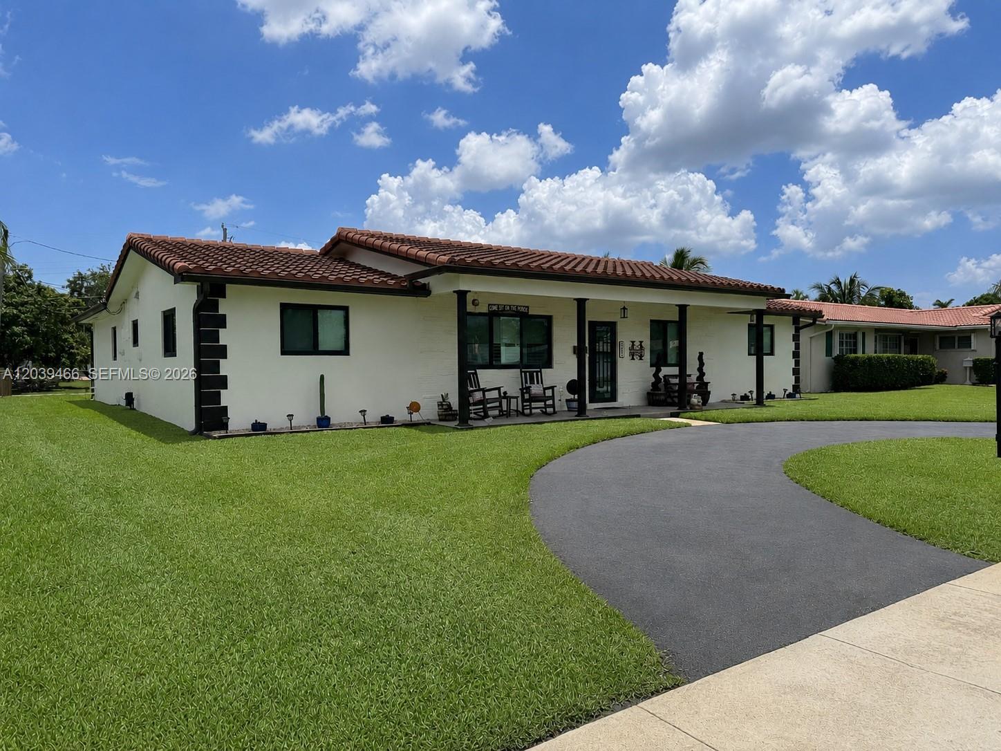 A single-story house with a red tile roof, white exterior, and a curved asphalt driveway — 4301 Adams St, Hollywood FL 33021, HOLLYWOOD, FL