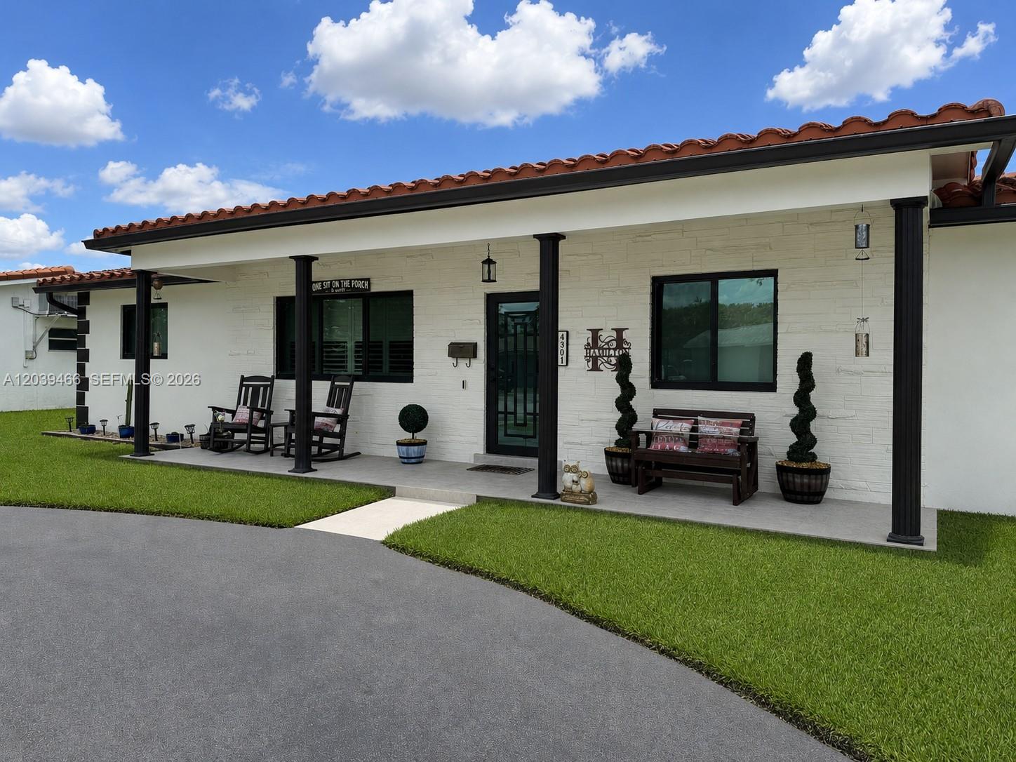 A single-story house with a white brick facade, a covered porch, and a tiled roof — 4301 Adams St, Hollywood FL 33021, HOLLYWOOD, FL