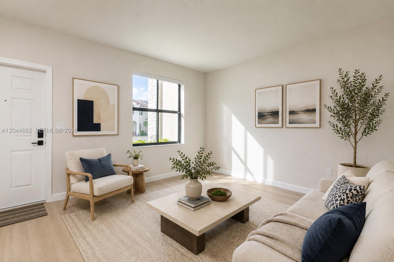 A living room features a sofa, an armchair, a coffee table, and wall art — 10079 SW 228 # 10079, Miami FL 33190, MIAMI, FL