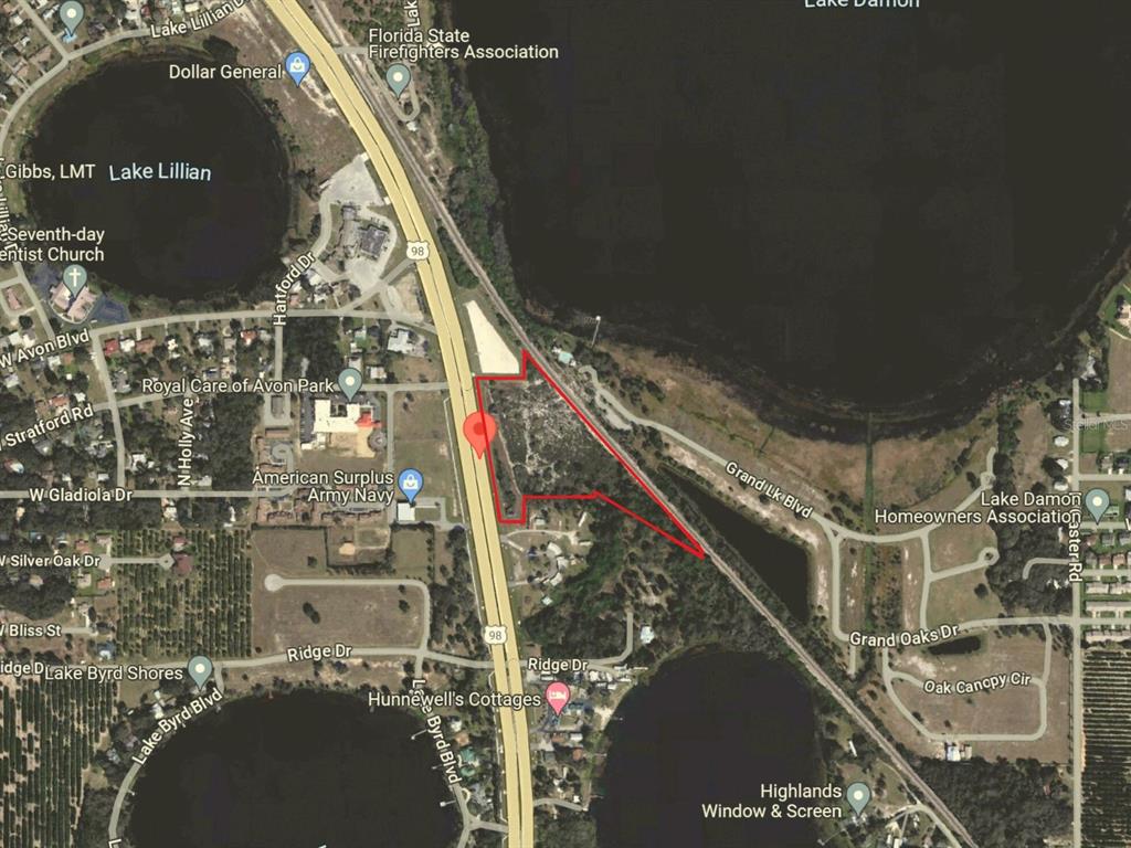 An aerial map shows a vacant parcel of land outlined in red near a lake — 2210 US HIGHWAY 27 N, AVON PARK, FL