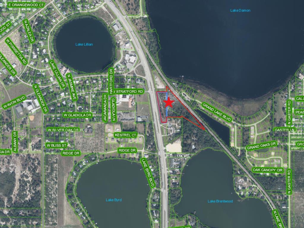 This is an aerial map showing a property highlighted with a red star and outline — 2210 US HIGHWAY 27 N, AVON PARK, FL