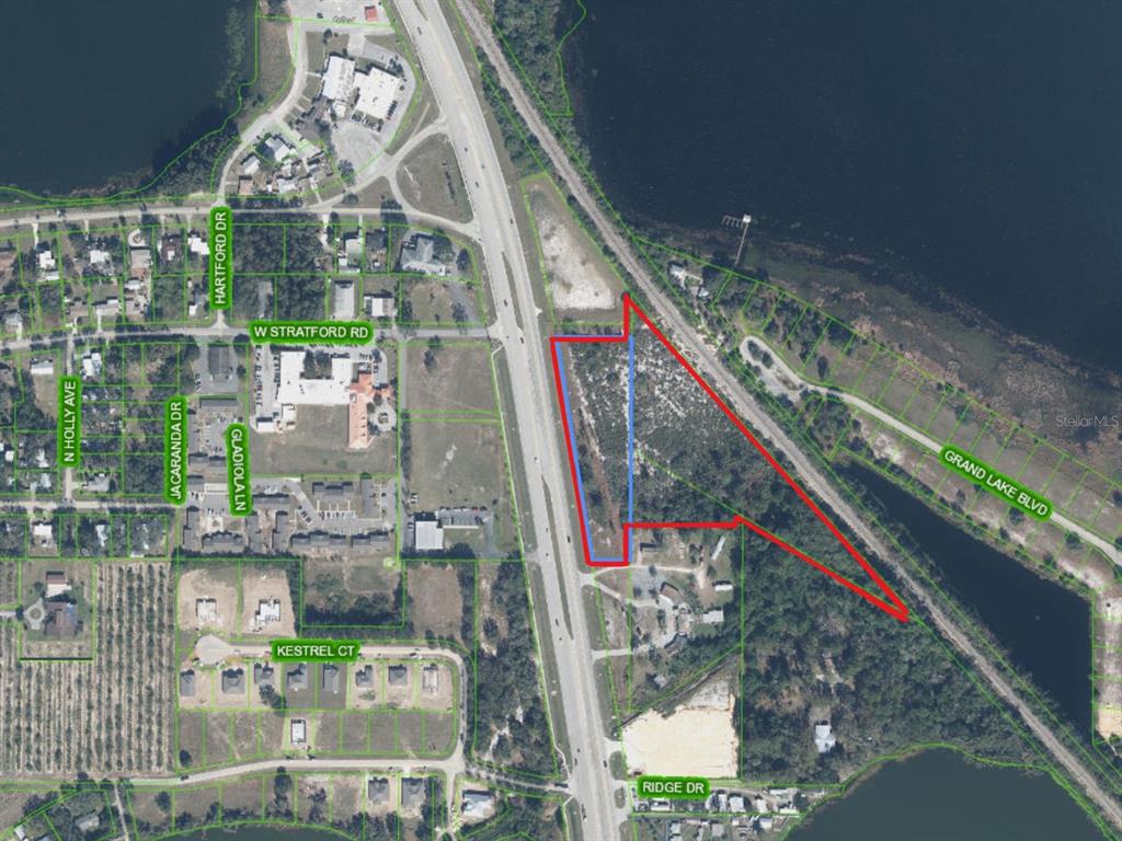 An aerial map shows a vacant, irregularly shaped parcel of land outlined in red — 2210 US HIGHWAY 27 N, AVON PARK, FL