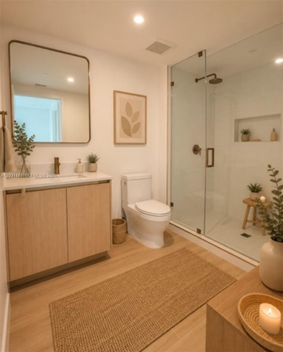A modern bathroom features a light wood vanity, a glass-enclosed shower, and neutral decor — 90 NE 32nd St # 624, Miami FL 33137, MIAMI, FL