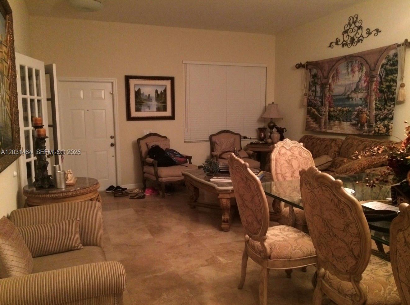 A living and dining area features tile flooring, traditional furniture, and a wall tapestry — 748 Tulip Cir, Weston FL 33327, WESTON, FL
