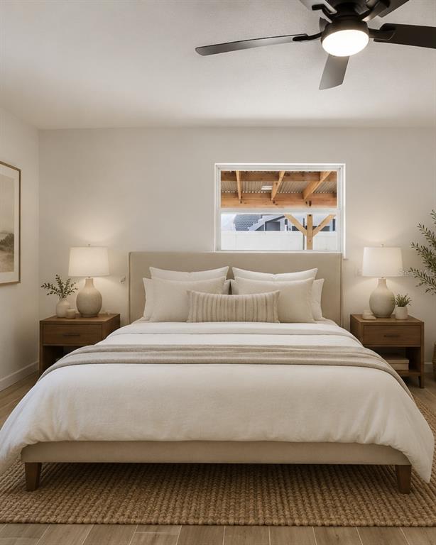 A bedroom features a neutral-toned bed, matching nightstands, table lamps, and a ceiling fan — 1734 MARYLAND AVENUE NE, ST PETERSBURG, FL
