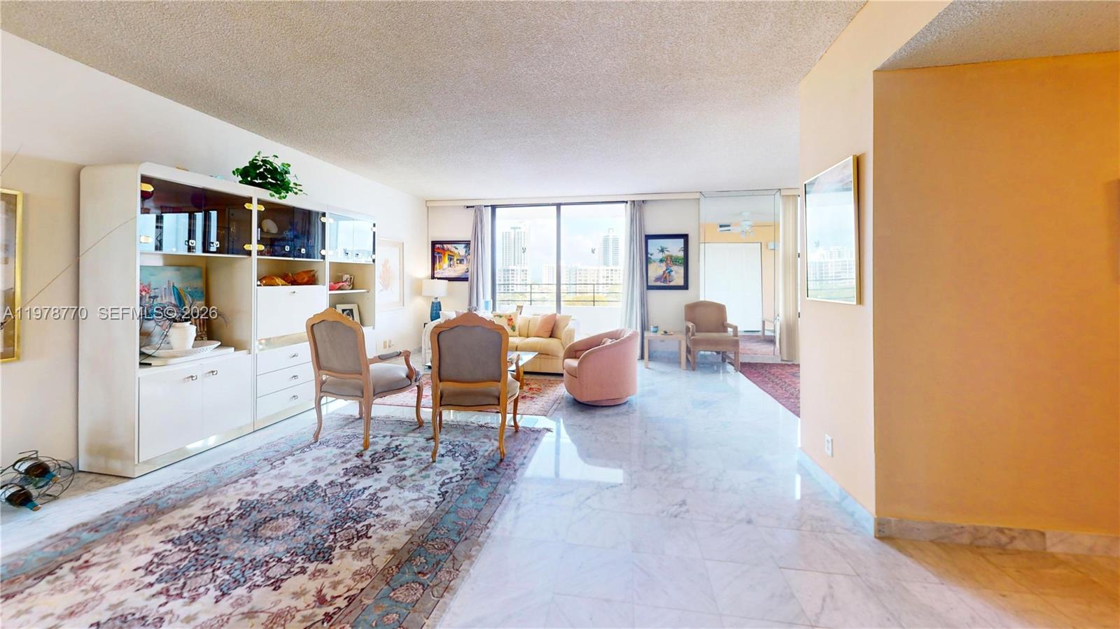 A living room features marble floors, a large wall unit, and a balcony with city views — 2500 PARKVIEW DR # 902, Hallandale Beach FL 33009, HALLANDALE BEACH, FL
