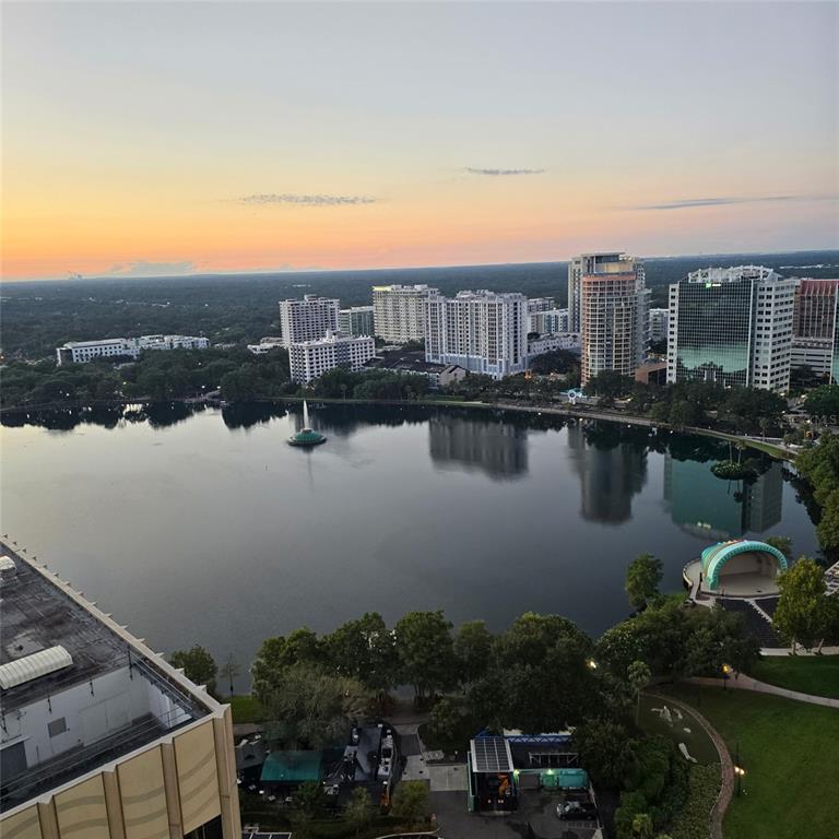 An elevated view of Lake Eola Park in Orlando with surrounding city buildings at sunset — 150 E ROBINSON STREET UNIT 2409, ORLANDO, FL