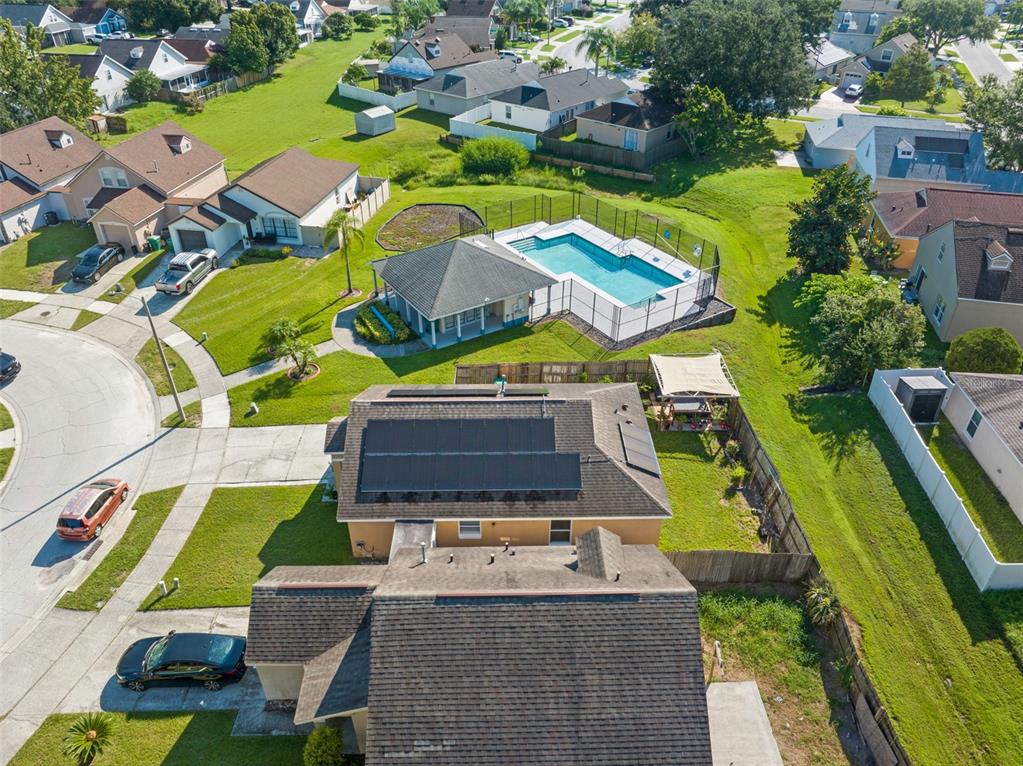 An aerial view shows a suburban house with solar panels, a pool, and a gazebo — 338 WINDFORD COURT, WINTER GARDEN, FL