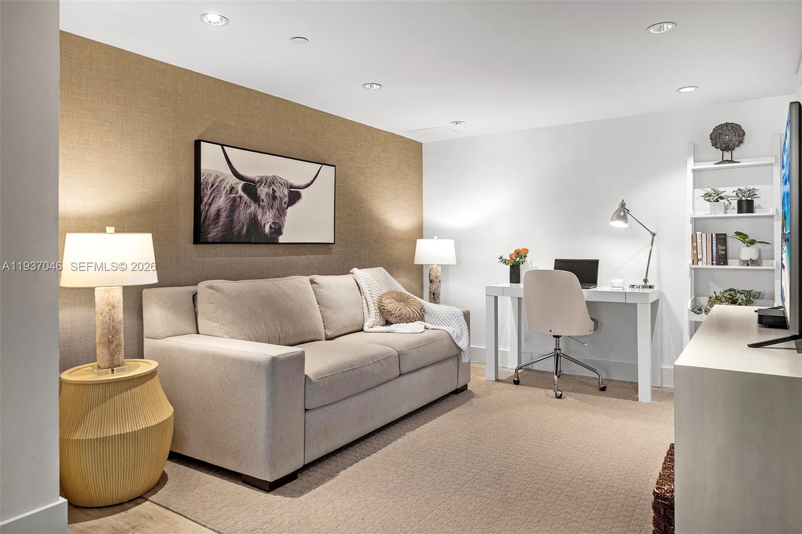 A home office and living area features a beige sofa, desk, and textured accent wall — 102 24th St # 1207, Miami Beach FL 33139, MIAMI BEACH, FL
