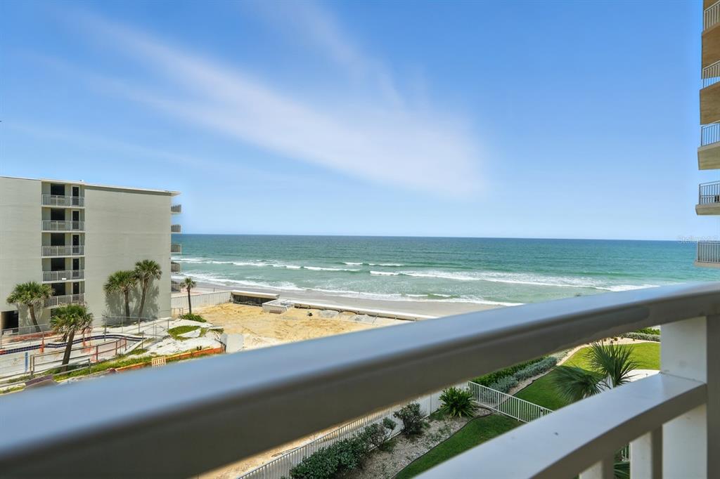 A view of the ocean and beach from a high-rise balcony with a metal railing — 2403 S ATLANTIC AVENUE UNIT 409, DAYTONA BEACH SHORES, FL