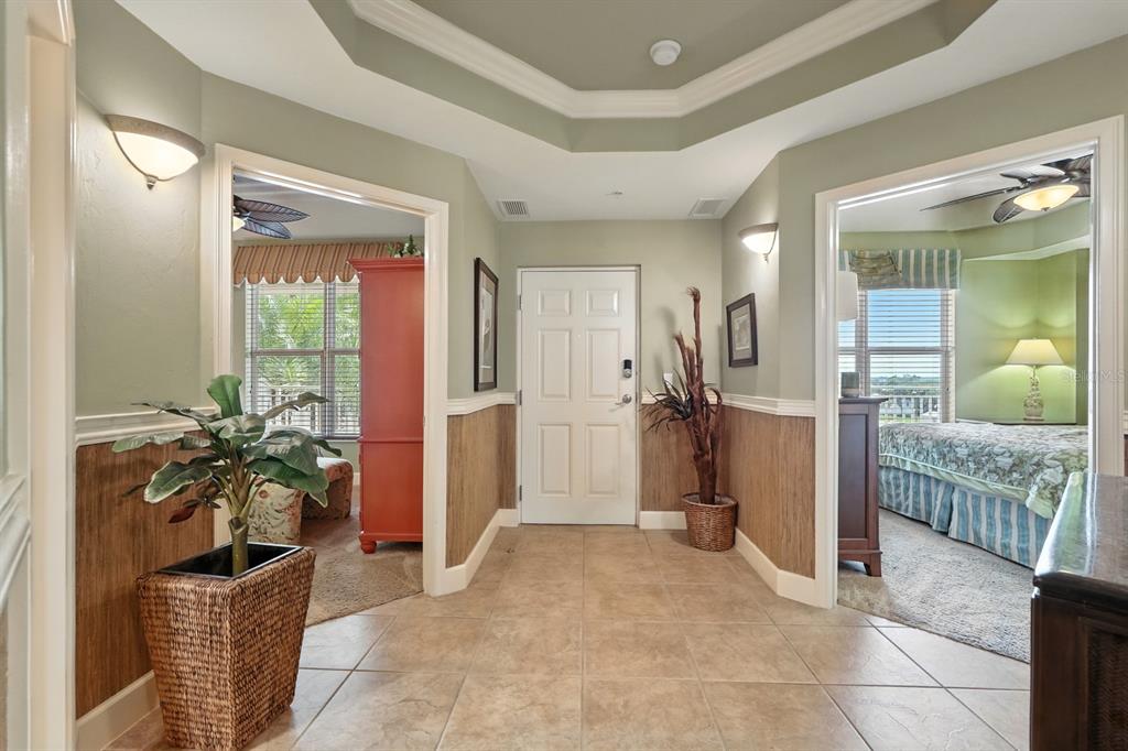 A tiled entryway features a white front door, tray ceiling, and two arched doorways — 2403 S ATLANTIC AVENUE UNIT 409, DAYTONA BEACH SHORES, FL
