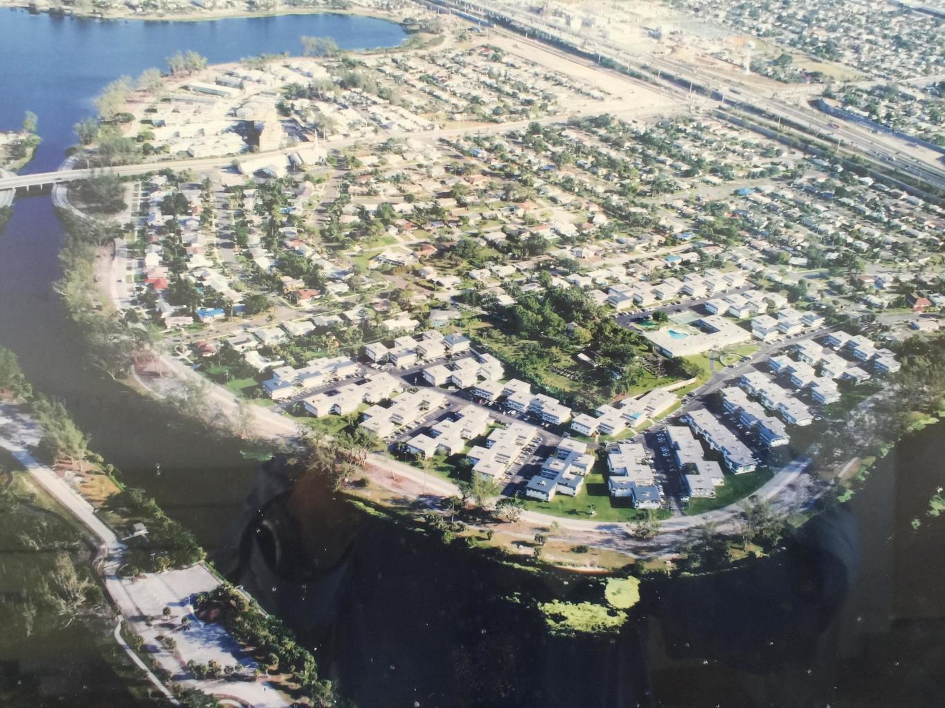 An aerial view shows a residential neighborhood situated along a winding river and lake — 2960 Lake Osborne Drive # 209, FL 33461, FL