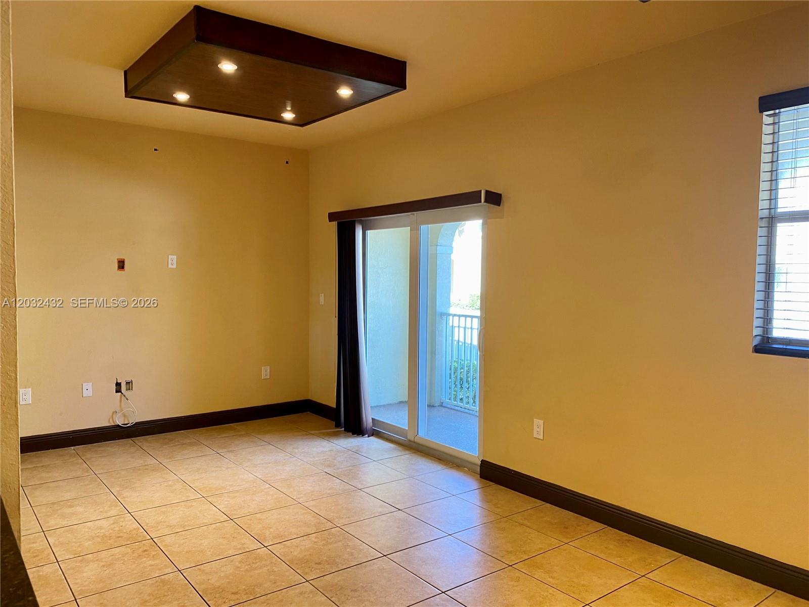 This room features tile flooring, a recessed ceiling light fixture, and sliding glass balcony doors — 8800 NW 107th CT # 110, Doral FL 33178, DORAL, FL