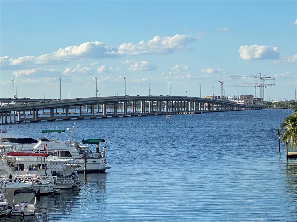 A long bridge spans a body of water with several boats docked in the foreground — 411 SOLONA STREET, PUNTA GORDA, FL