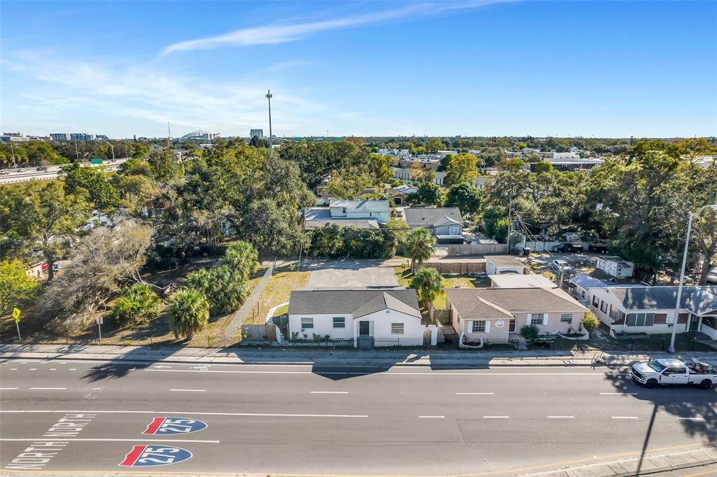 An aerial view shows two small houses situated along a multi-lane road with trees — 2140 22ND AVENUE N, ST PETERSBURG, FL