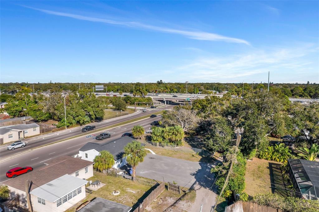 An aerial view shows a residential property next to a multi-lane road and highway overpass — 2140 22ND AVENUE N, ST PETERSBURG, FL
