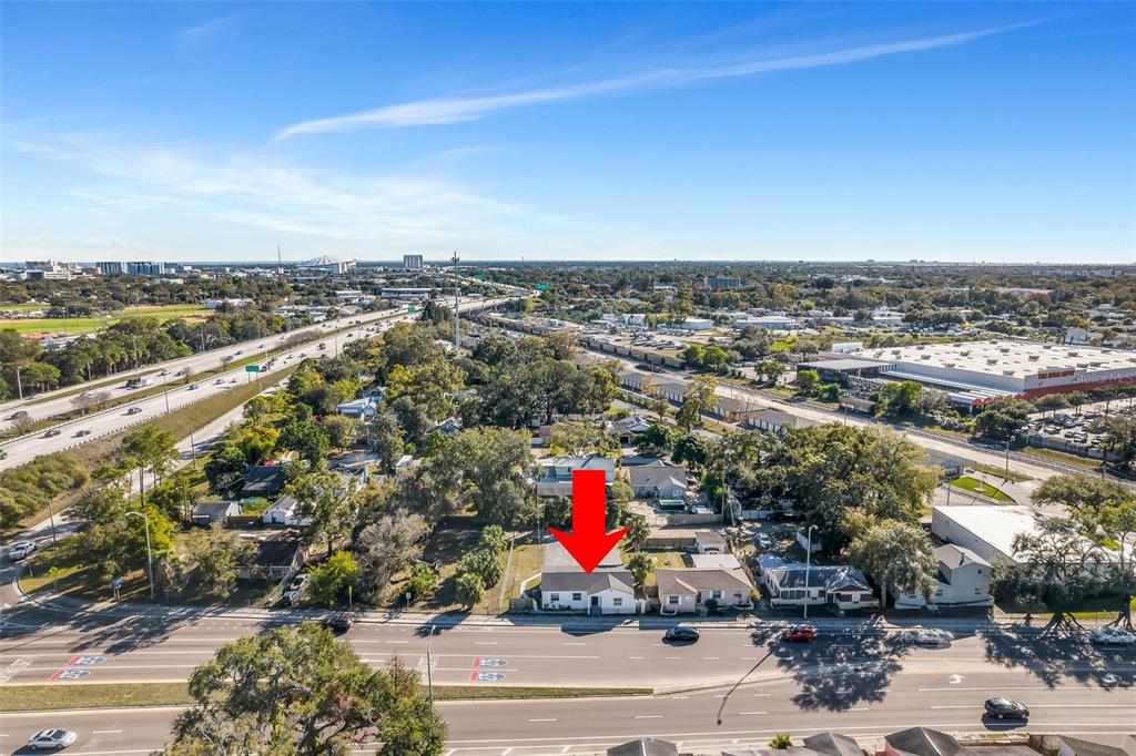 An aerial view shows a single-story house with a red arrow pointing to its roof — 2140 22ND AVENUE N, ST PETERSBURG, FL