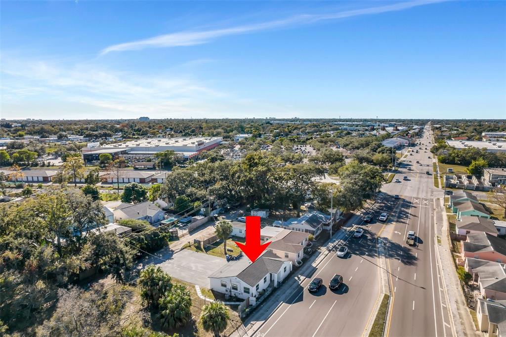 An aerial view of a single-story house with a red arrow pointing to the roof — 2140 22ND AVENUE N, ST PETERSBURG, FL