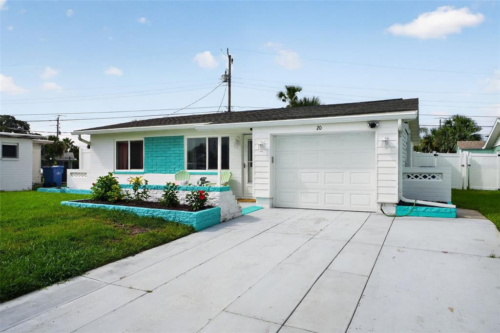 A single-story house with a white exterior, turquoise accents, and a concrete driveway — 20 SUNNY SHORE DRIVE, ORMOND BEACH, FL