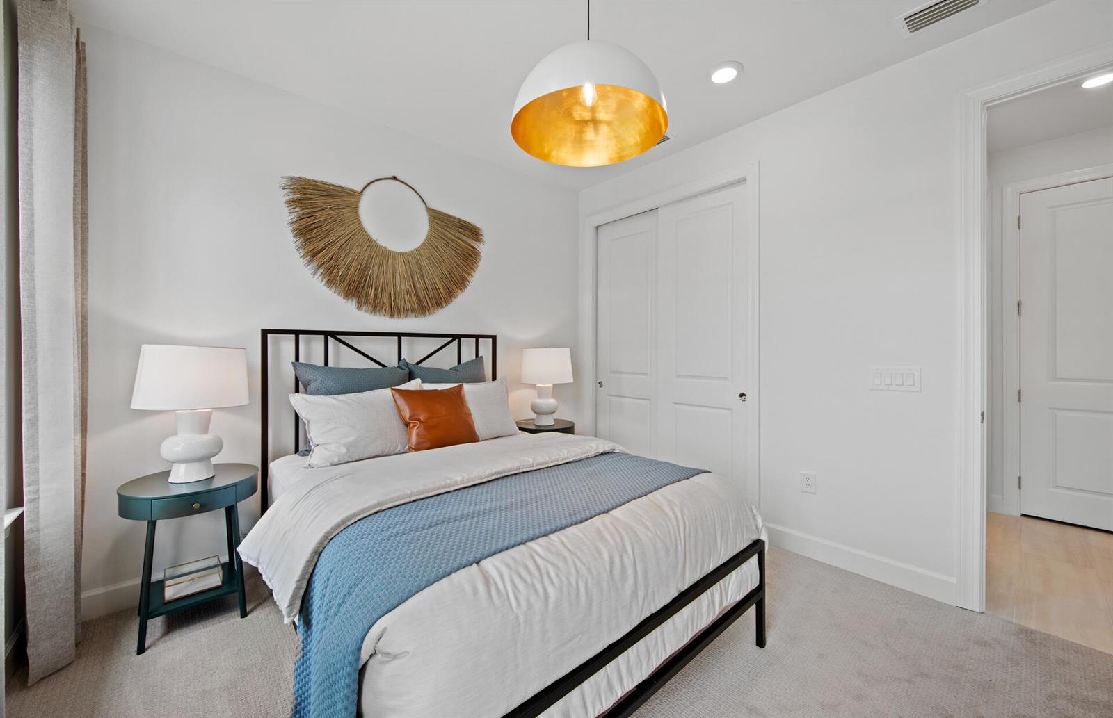 A bedroom features a metal bed frame, a blue throw blanket, and a gold-lined pendant light — 3968 Sweet Alyssum Terrace, FL 33920, FL