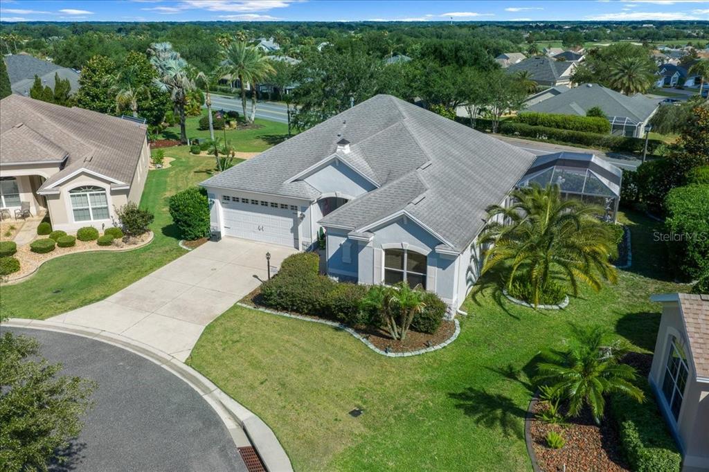 An aerial view of a single-story suburban house with a gray roof and concrete driveway — 1606 SNELLING AVENUE, THE VILLAGES, FL