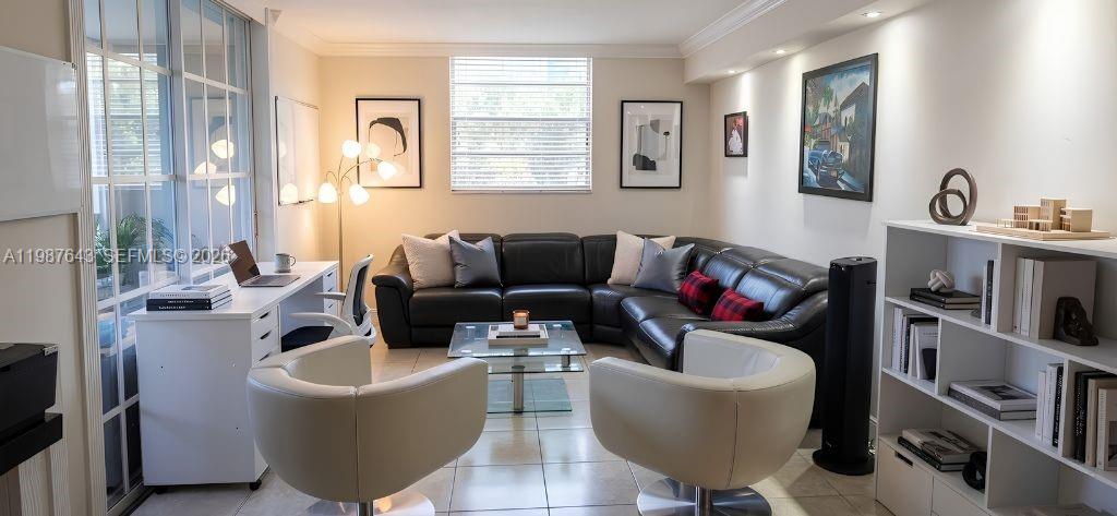 A living room features a black sectional sofa, two white swivel chairs, and a desk — 5055 NW 7th St # 206, Miami FL 33126, MIAMI, FL