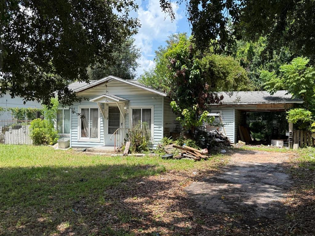 A single-story light blue house with a front porch and an attached carport — 2358 OLD DIXIE HIGHWAY, KISSIMMEE, FL