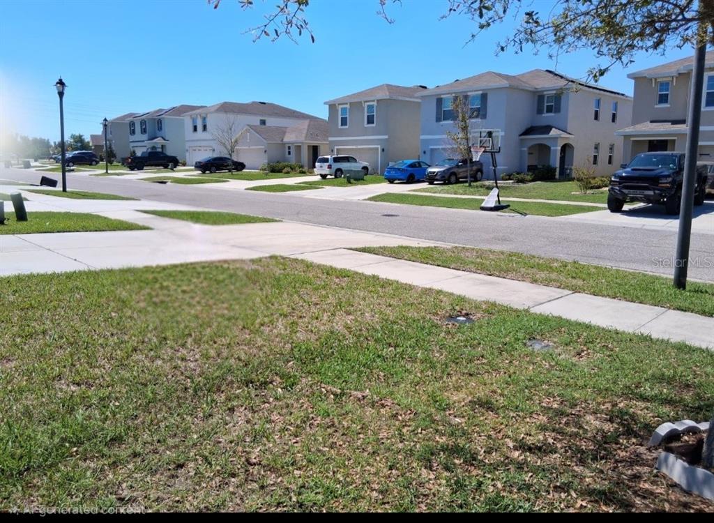 A suburban street view showing houses, parked cars, a basketball hoop, and a grassy lawn — 6656 SEAWAY DRIVE, BROOKSVILLE, FL