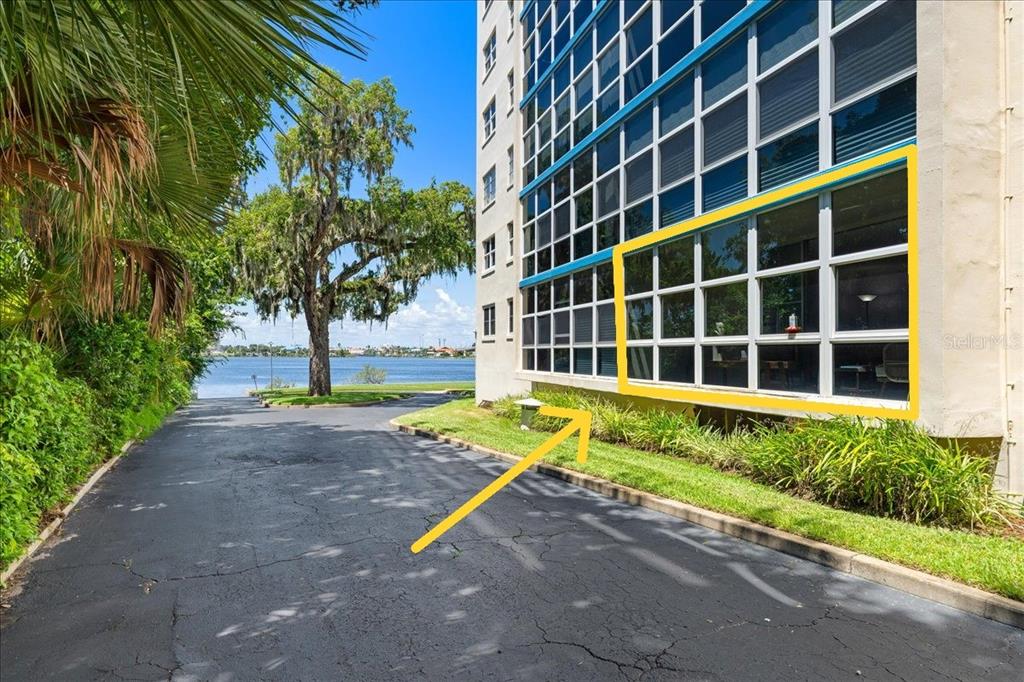 An exterior view of a multi-story apartment building with a highlighted ground-floor window unit — 1224 S PENINSULA DRIVE UNIT 104, DAYTONA BEACH, FL
