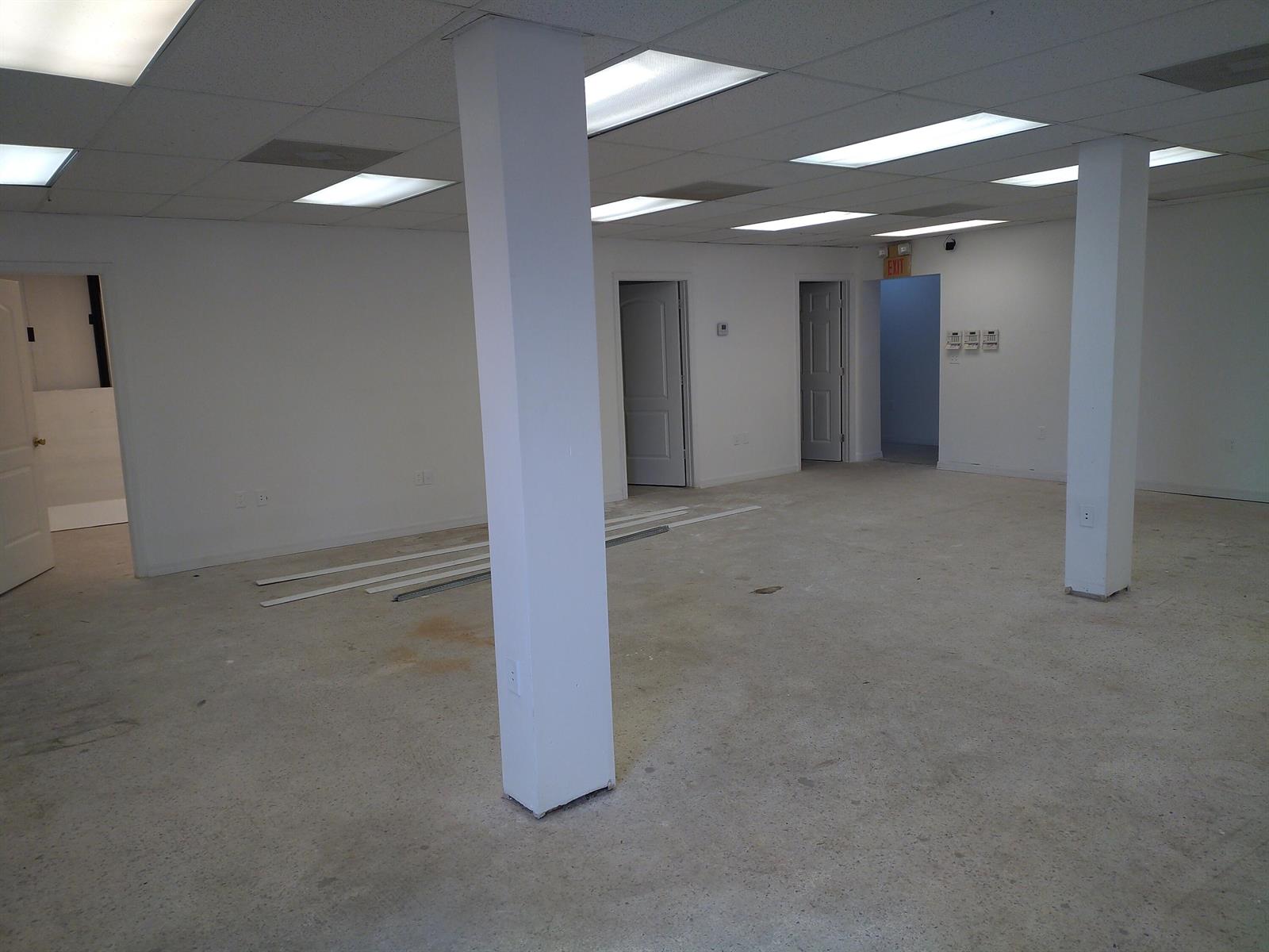 An empty commercial office space with white walls, concrete floors, and two support columns — 3625 Metzger Road, Fort Pierce FL 34947, FORT PIERCE, FL
