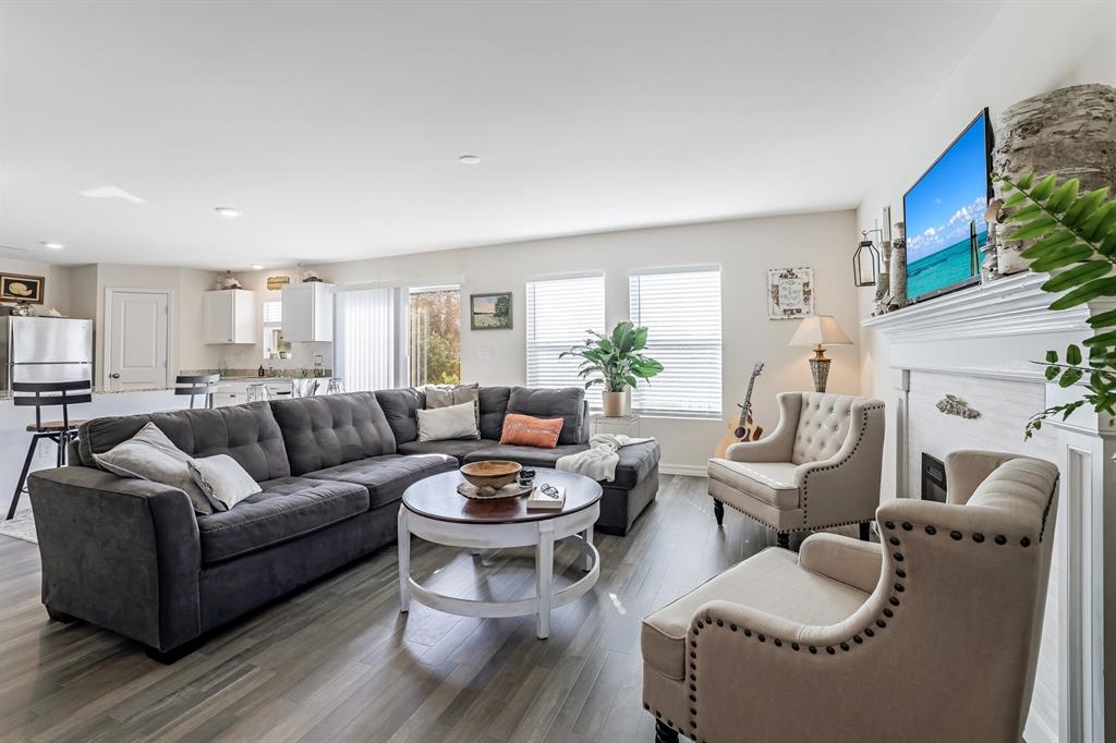 A living room features a large gray sectional, two beige armchairs, and a fireplace — 1091 CAZENOVIA STREET, PORT CHARLOTTE, FL