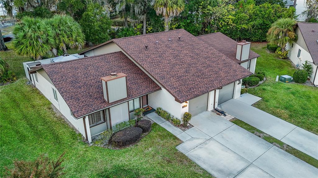 An aerial view of a single-story house with a brown shingled roof and driveway — 3601 NE 17TH LANE, OCALA, FL