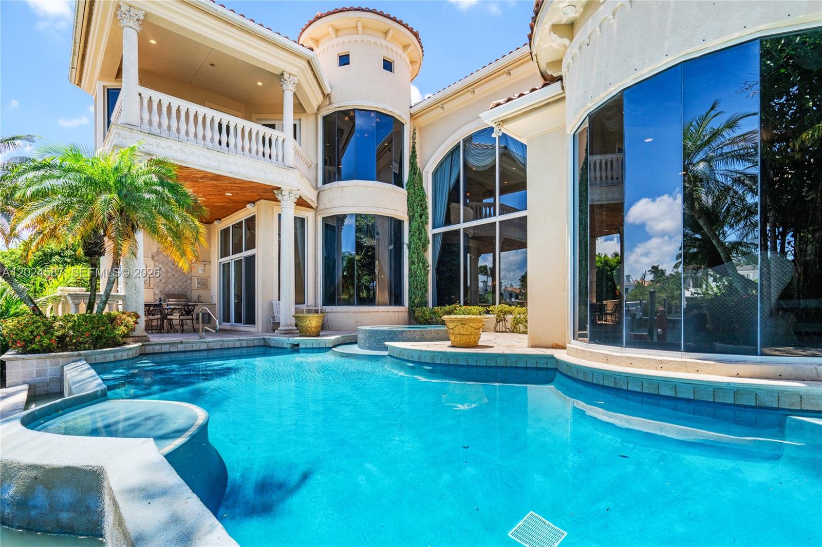 A luxury home exterior features a swimming pool, a turret, and large glass windows — 832 Harbour Isle Place, North Palm Beach FL 33410, NORTH PALM BEACH, FL