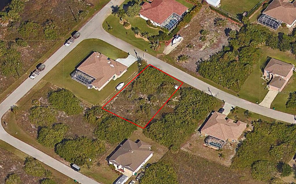 An aerial view shows a vacant, rectangular residential lot outlined in red between two houses — 14127 SAUL LANE, PORT CHARLOTTE, FL