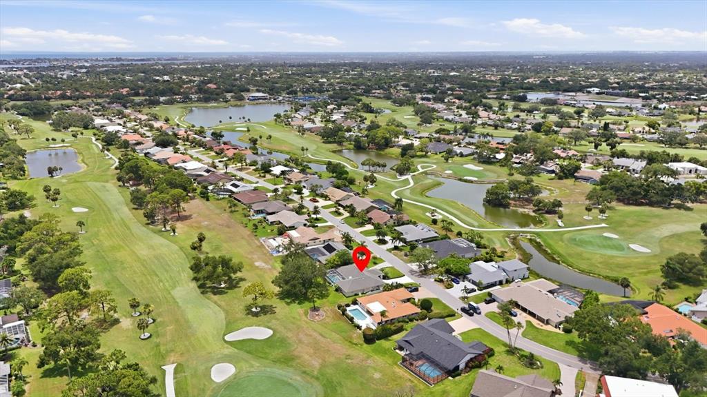 An aerial view shows a residential neighborhood with houses situated along a golf course — 3900 TORREY PINES BOULEVARD, SARASOTA, FL