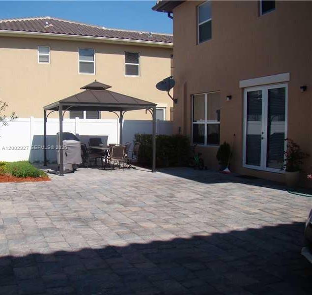 A kitchen features dark wood cabinets, stainless steel appliances, and light granite countertops — 9160 SW 171st Ct # 0, Miami FL 33196, MIAMI, FL