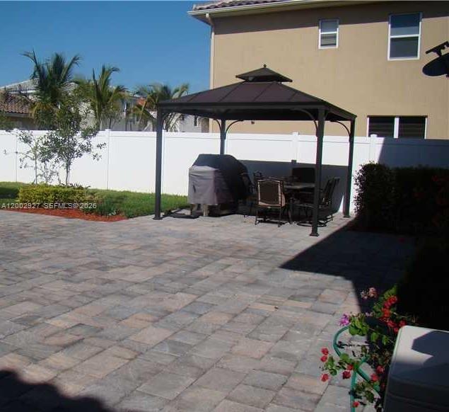 A kitchen features dark wood cabinets, stainless steel appliances, and speckled granite countertops — 9160 SW 171st Ct # 0, Miami FL 33196, MIAMI, FL