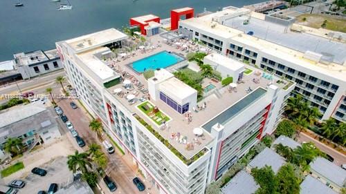 An aerial view shows a multi-story building with a rooftop pool, deck, and lounge area — 777 N Ocean Dr # S216, Hollywood FL 33019, HOLLYWOOD, FL