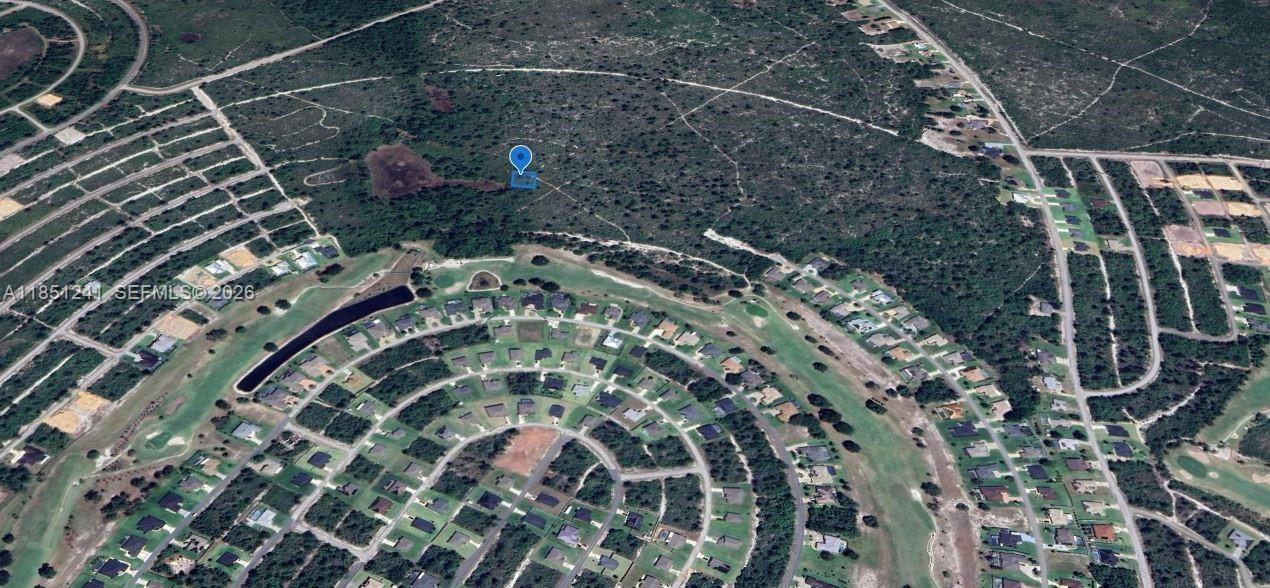 An aerial view shows a community clubhouse with a pool, playground, and parking lot — 6579 San Bruno Dr, Sebring FL 33872, SEBRING, FL