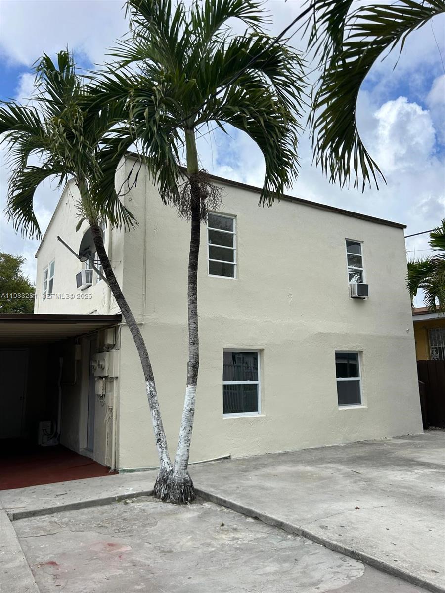 A two-story beige building with palm trees and a concrete driveway in front — 2908 NW 14 ct # 1, Miami FL 33142, MIAMI, FL