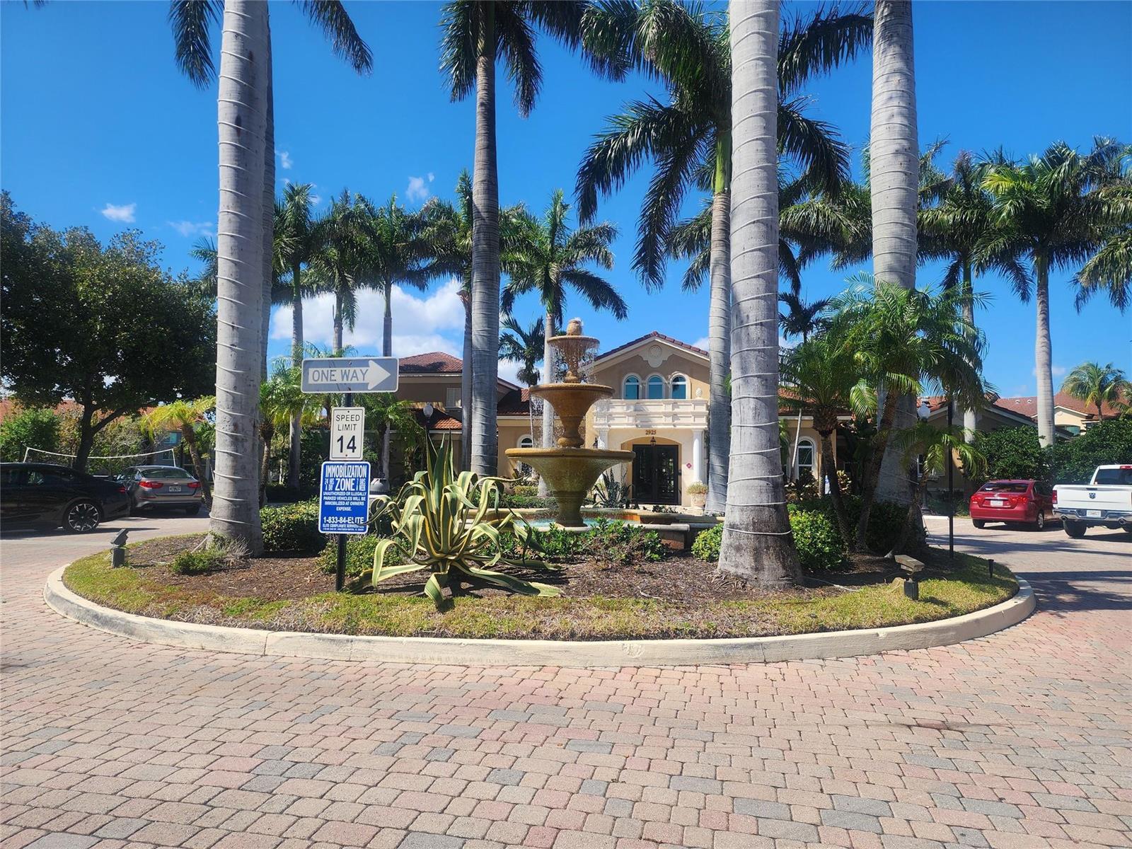 A balcony with numerous potted plants, a small table, and chairs viewed through sliding glass doors — 317 Villa Circle # 317, Boynton Beach FL 33435, BOYNTON BEACH, FL