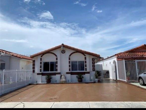 A kitchen features dark cabinets, light speckled countertops, a double sink, and a dining area — 2854 W 75th Ter, Hialeah FL 33018, HIALEAH, FL