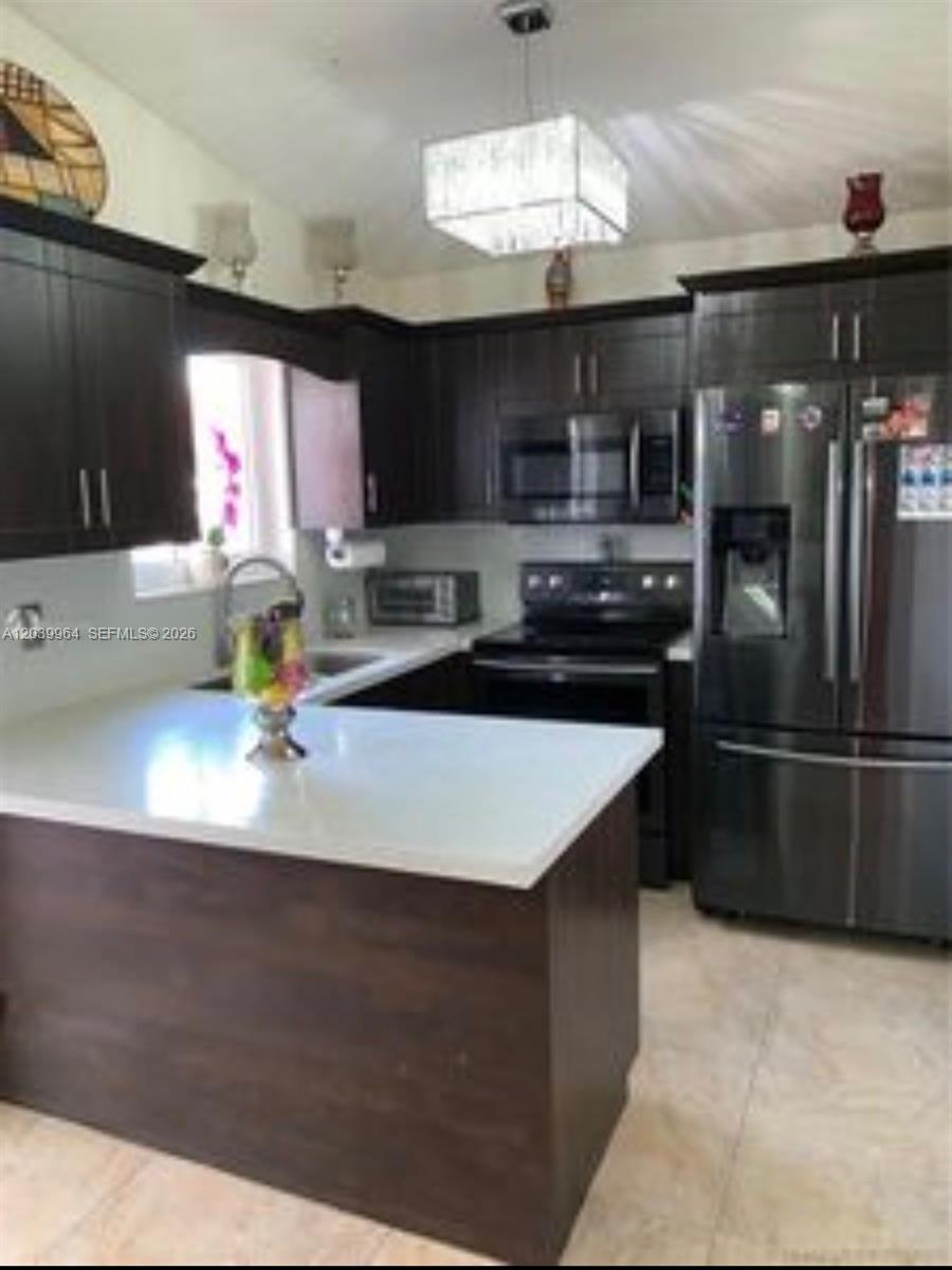 A room with tiled floors, a window with blinds, and a glass door leading outside — 2854 W 75th Ter, Hialeah FL 33018, HIALEAH, FL