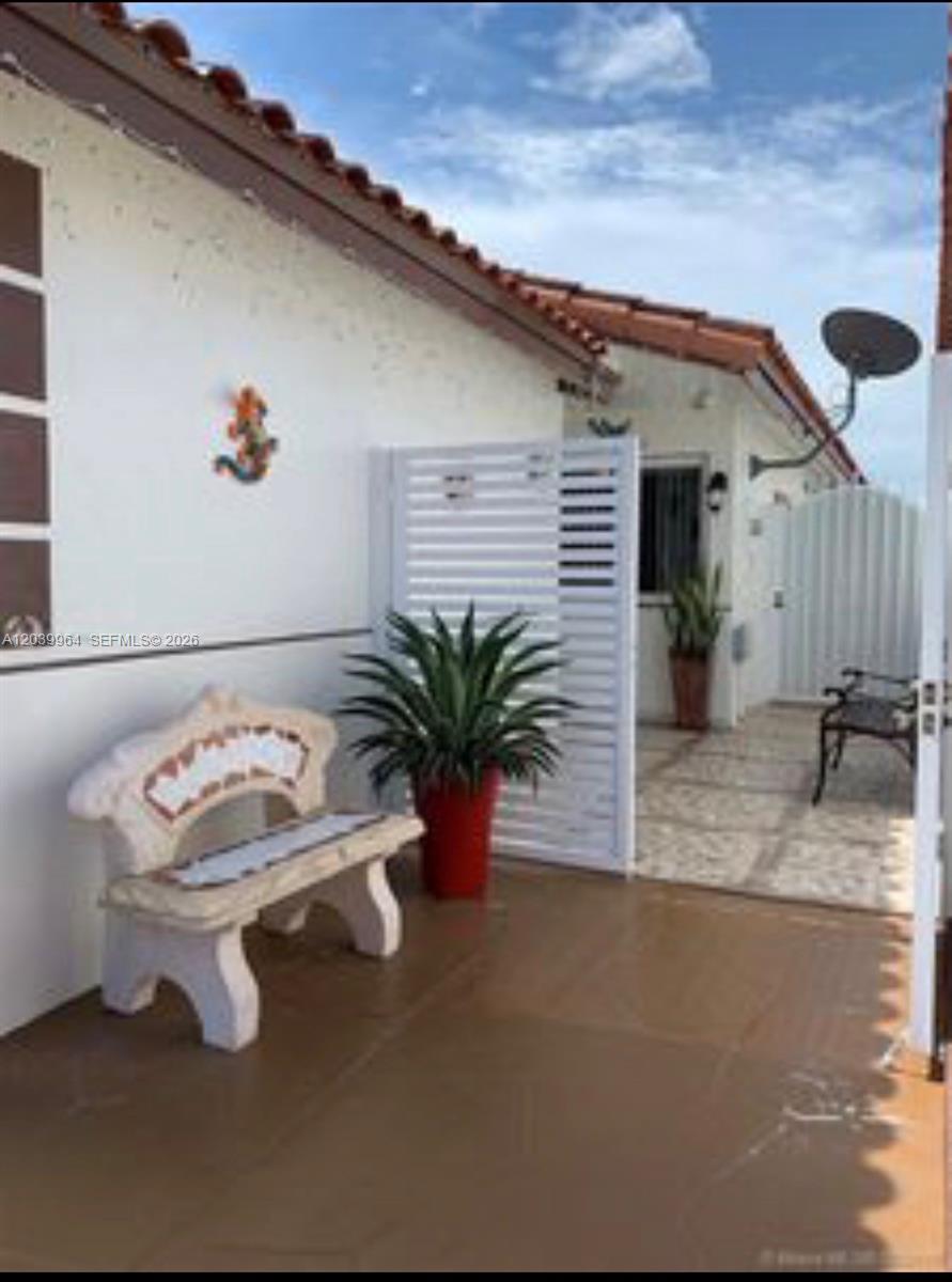 An empty room features white walls, beige tile flooring, and two modern ceiling light fixtures — 2854 W 75th Ter, Hialeah FL 33018, HIALEAH, FL