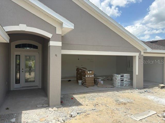 A front view of a house under construction showing an open garage and entryway — 7184 SW 179TH COURT ROAD, DUNNELLON, FL