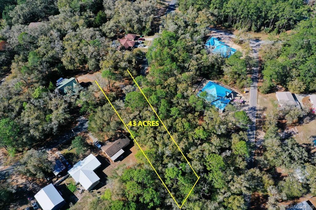 An aerial view shows a wooded lot marked as 43 acres surrounded by residential houses — 2663 W CYPRESS DRIVE, DUNNELLON, FL